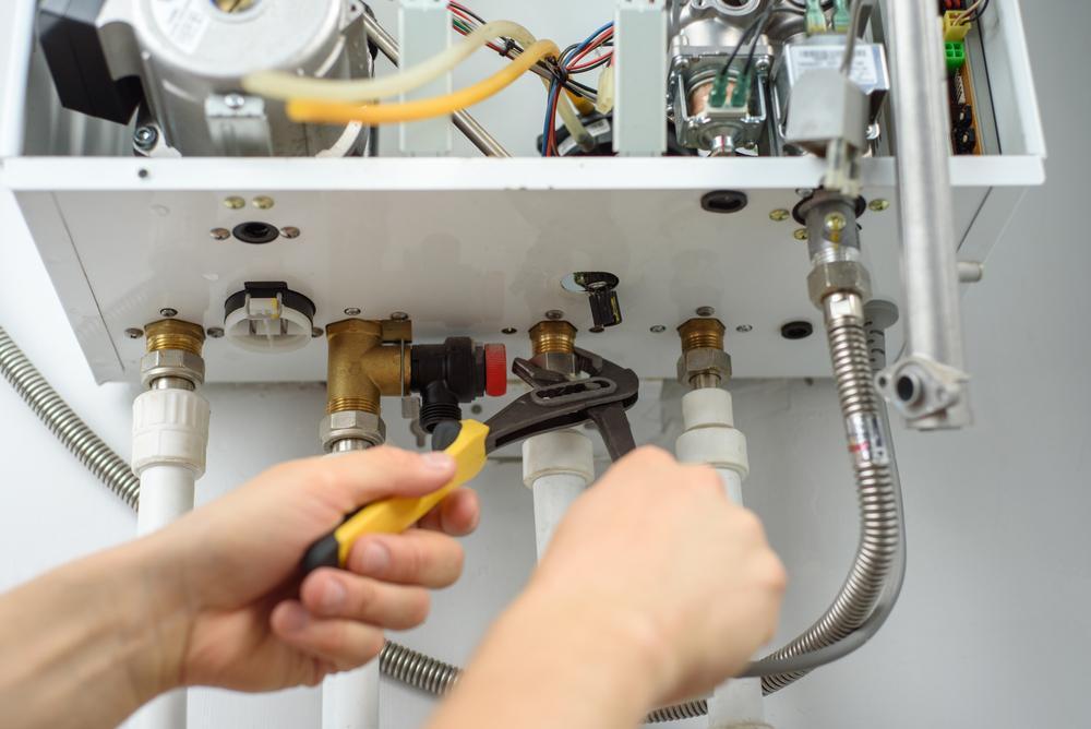 Boiler engineer works on boiler